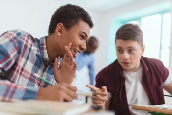 Two boys chatting in class